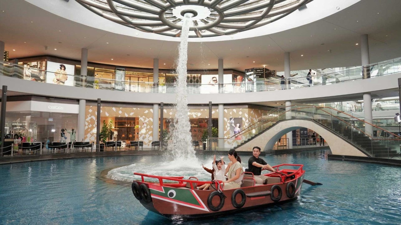 A family enjoying an indoor Sampan Ride to celebrate Father' Day in Singapore